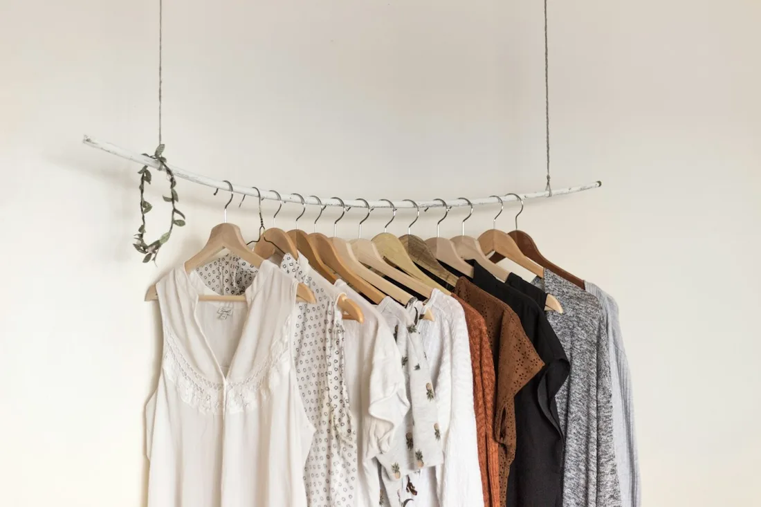 A carefully arranged rail of neutral clothes